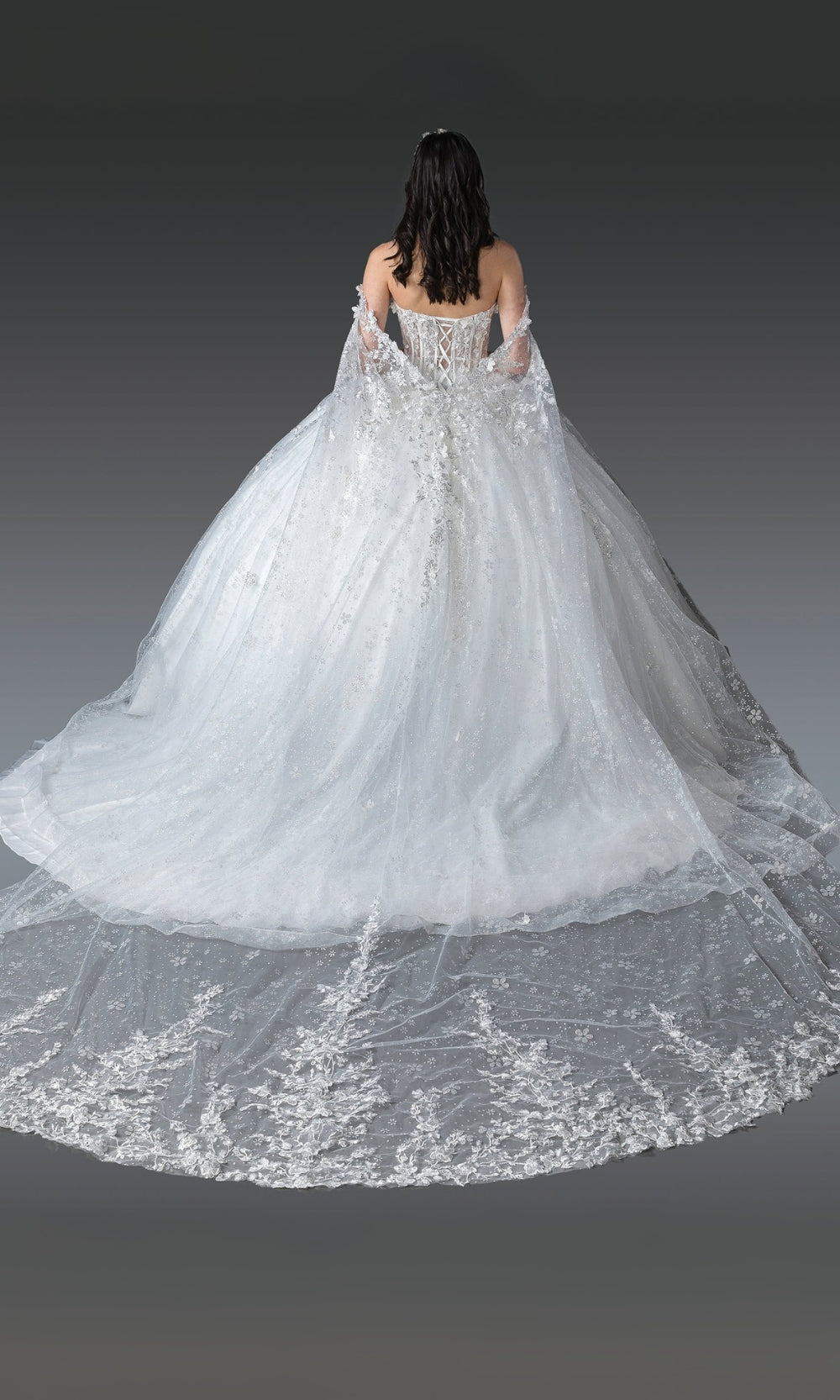 White wedding dress with floral details on a plain background