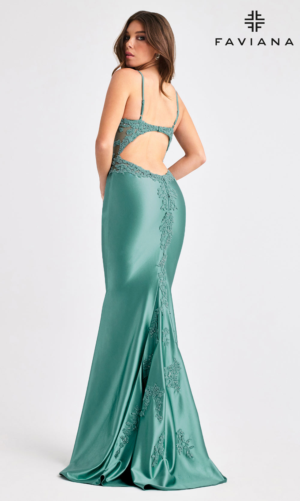 Teal evening gown with cut-out design on a white background, featuring the Faviana brand.