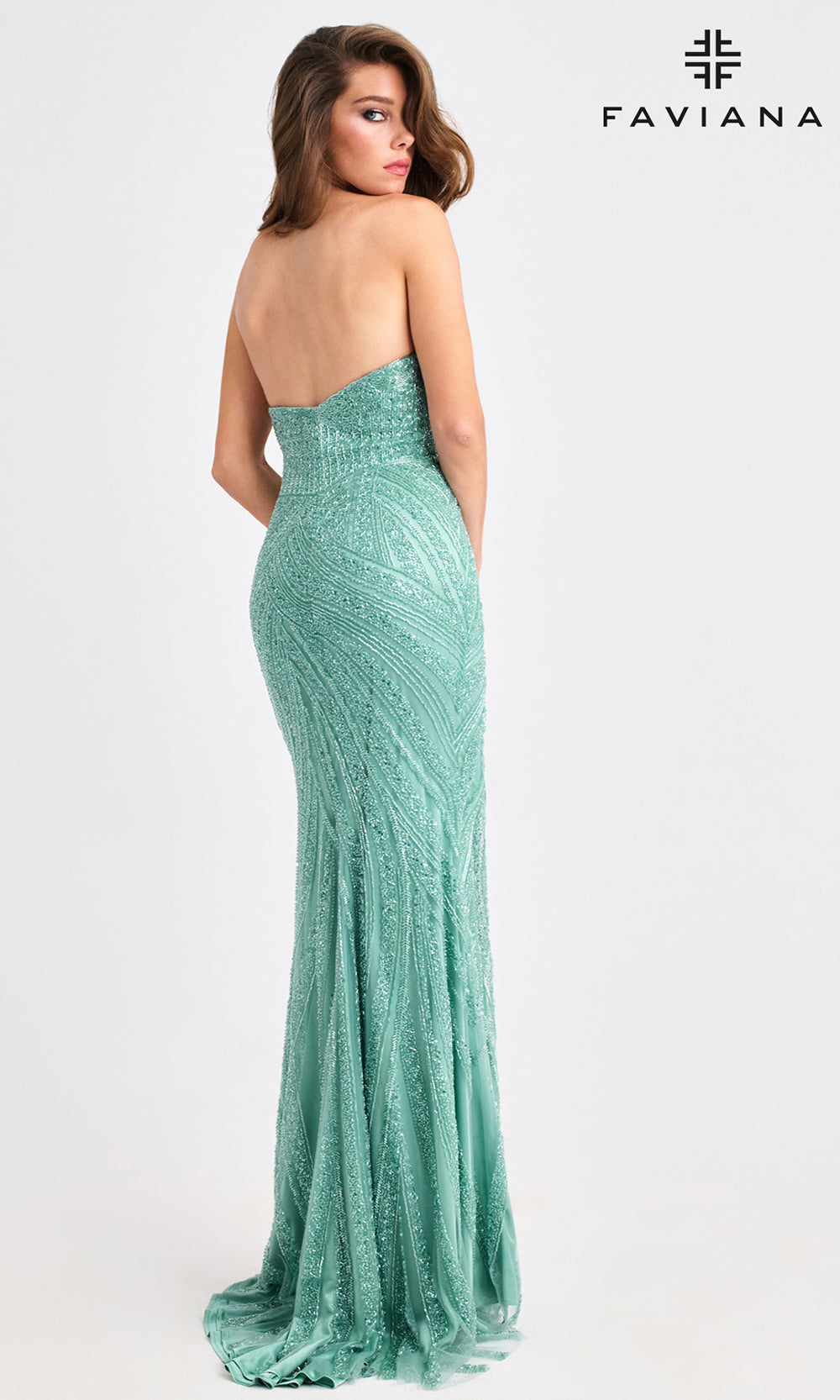 Woman wearing a strapless green evening gown with Faviana branding on a white background
