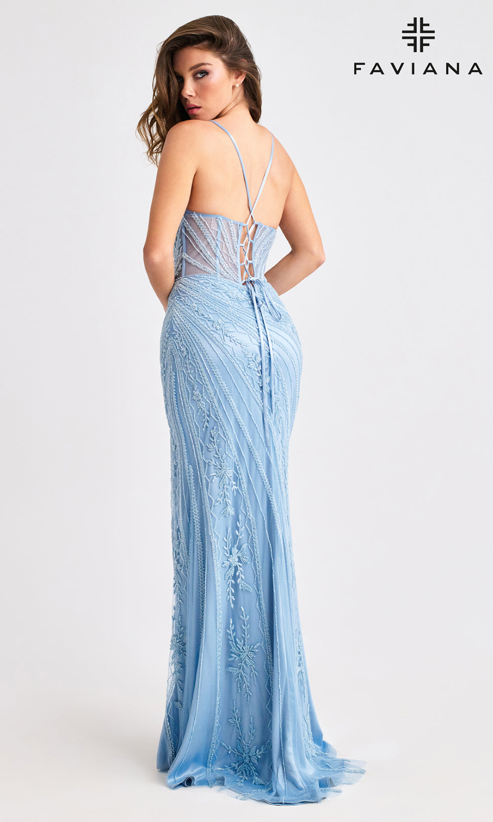 Woman wearing a light blue lace evening gown with 'Faviana' branding on a white background