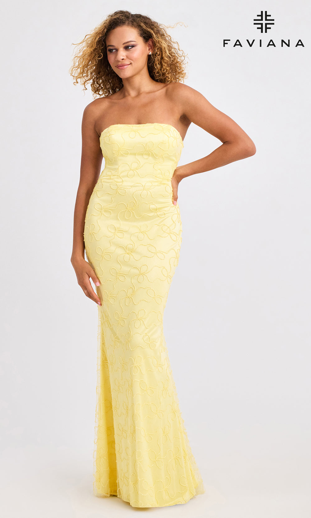 Woman wearing a yellow strapless gown on a white background with Faviana branding.