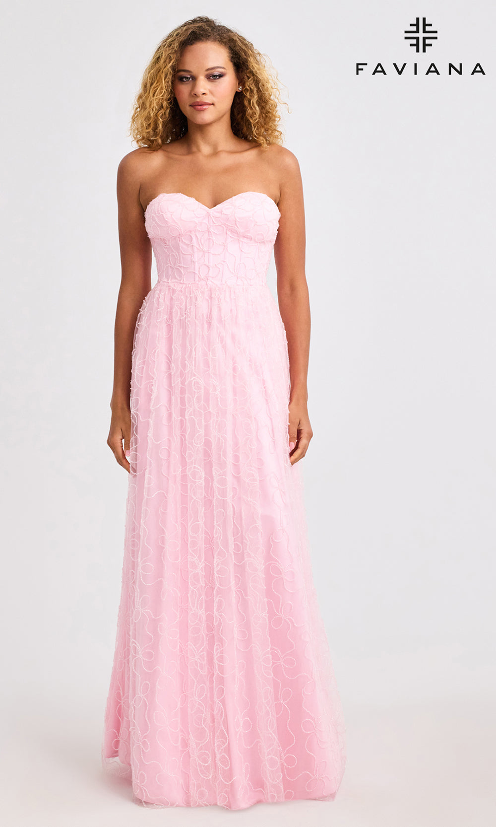 Woman wearing a pink strapless gown on a white background with Faviana branding.