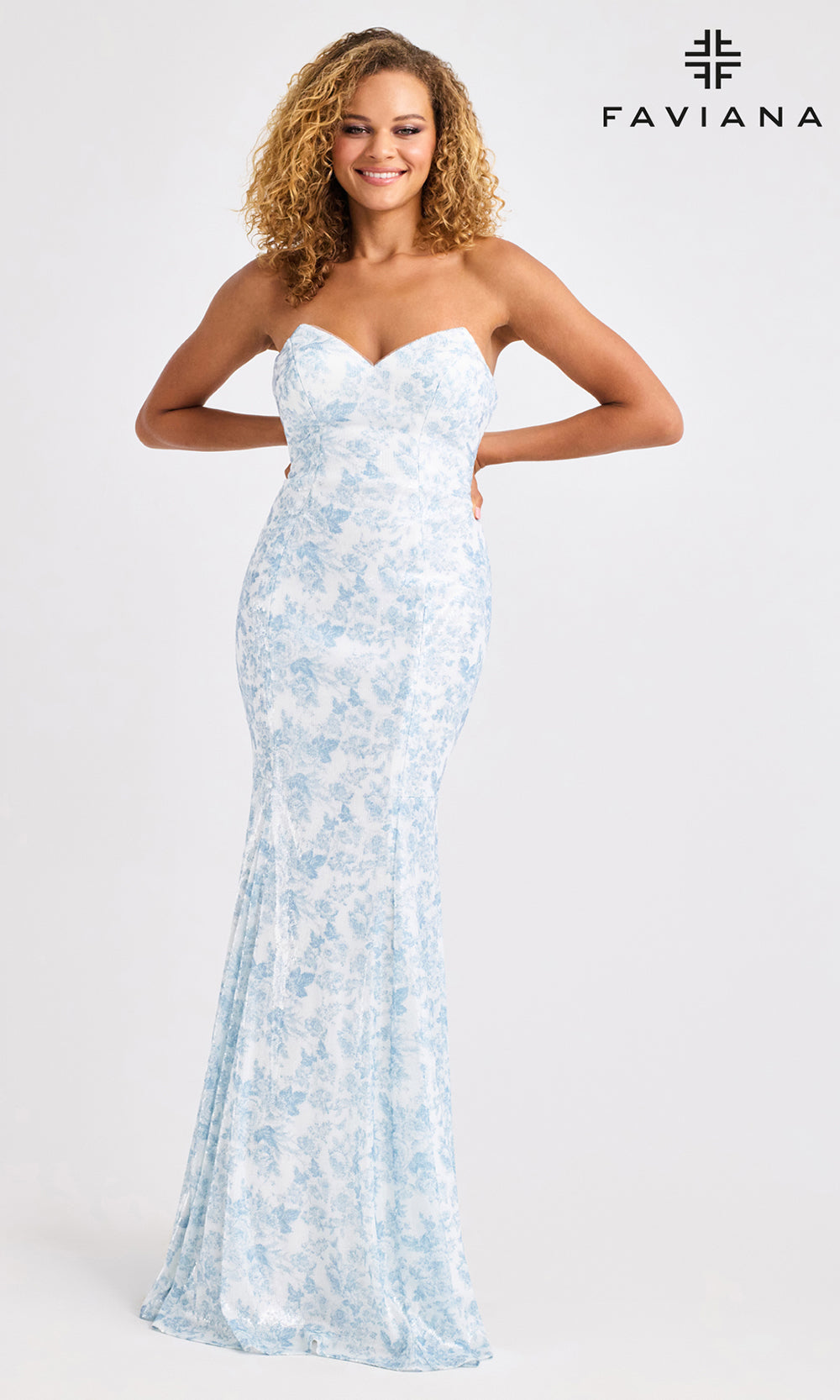 Woman wearing a strapless light blue floral dress on a white background with Faviana branding.