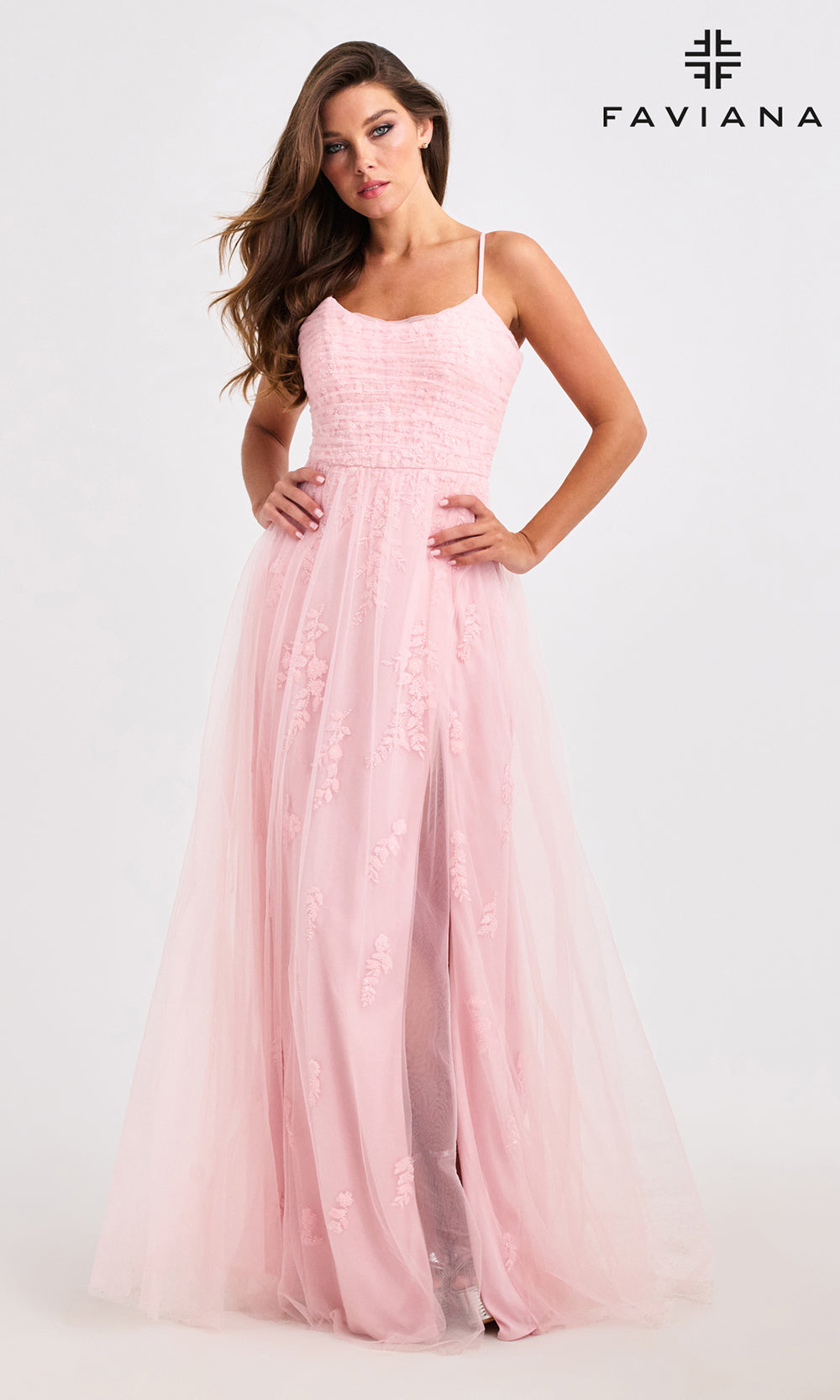 Woman wearing a pink dress with Faviana branding on a white background