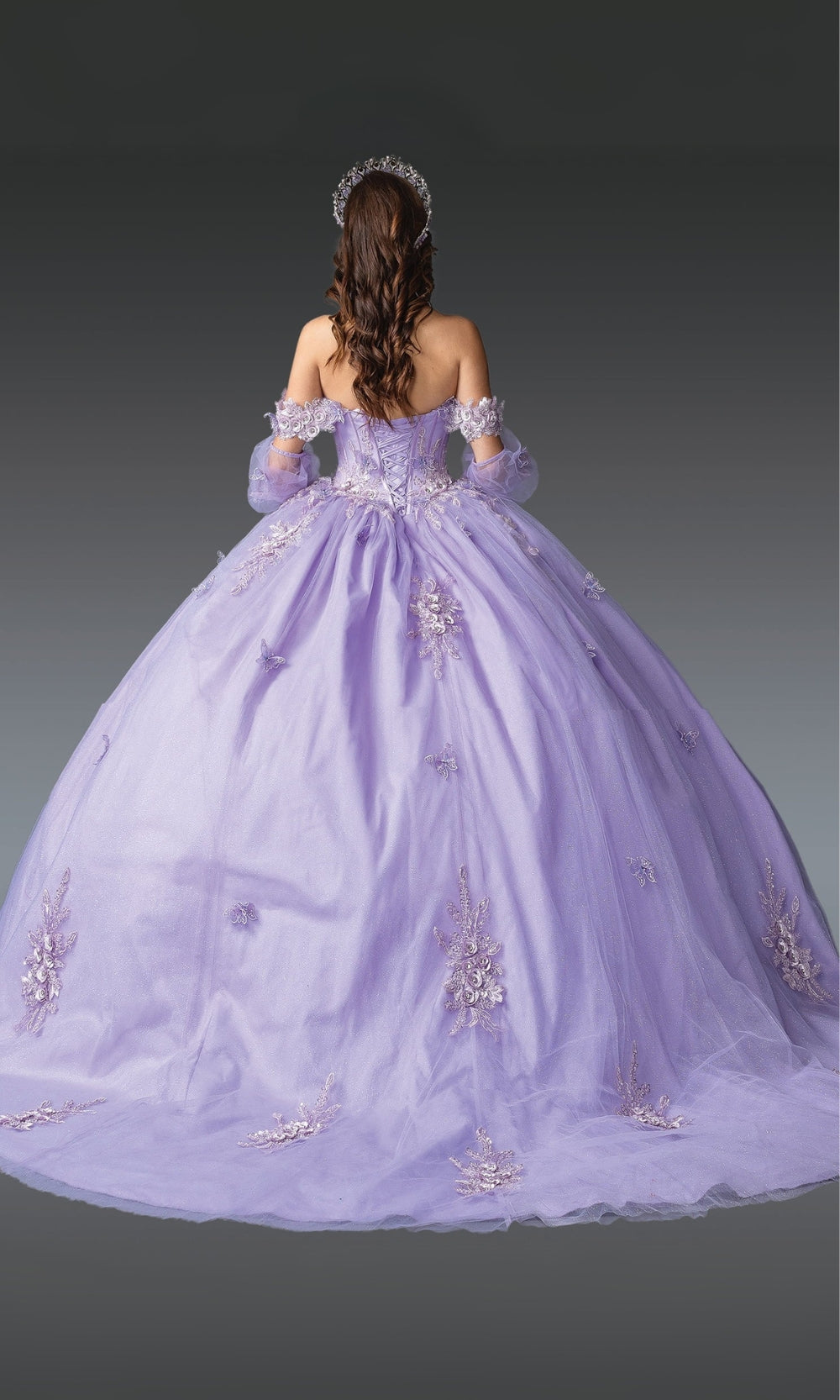 Purple ball gown with intricate details on a plain background