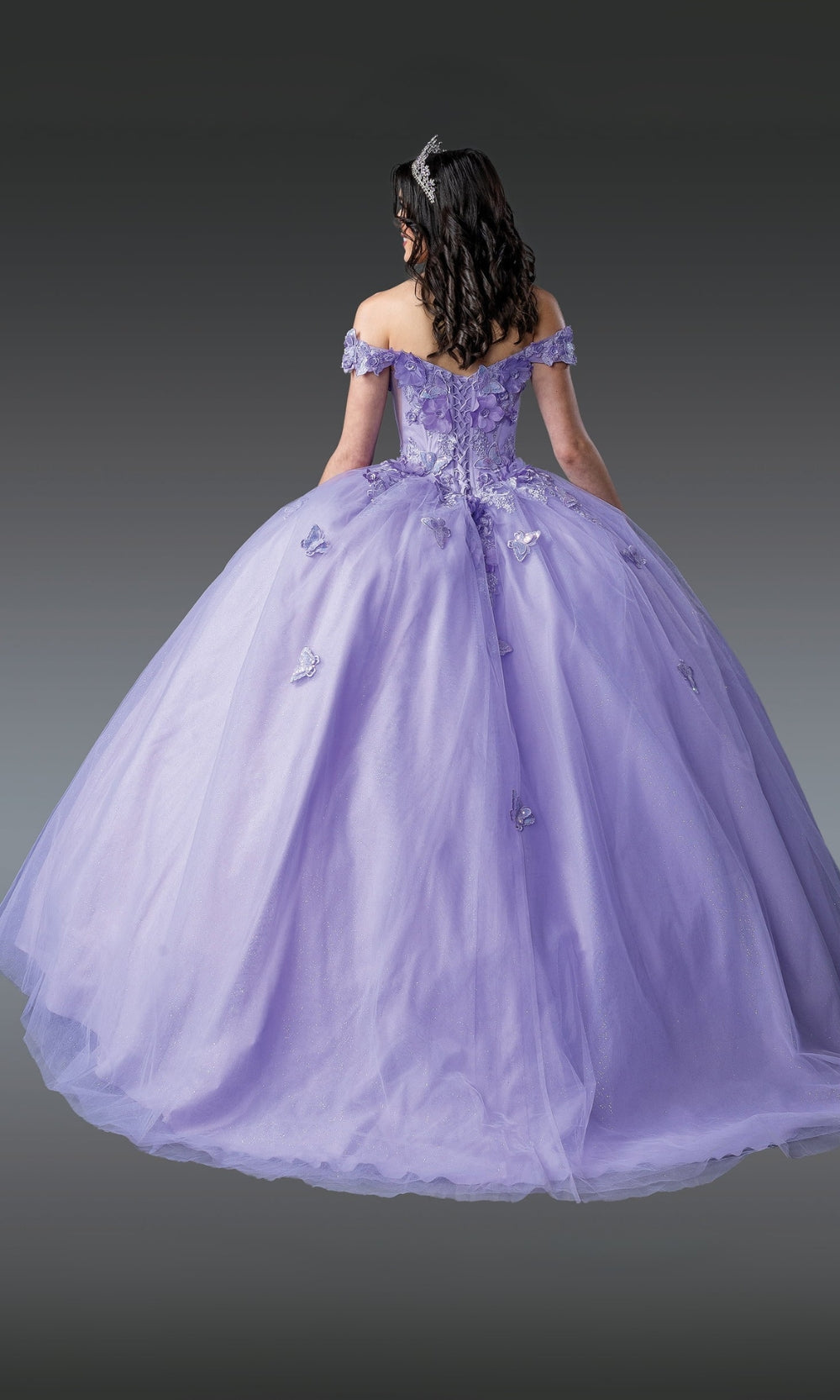Purple ball gown with intricate detailing on a gray background