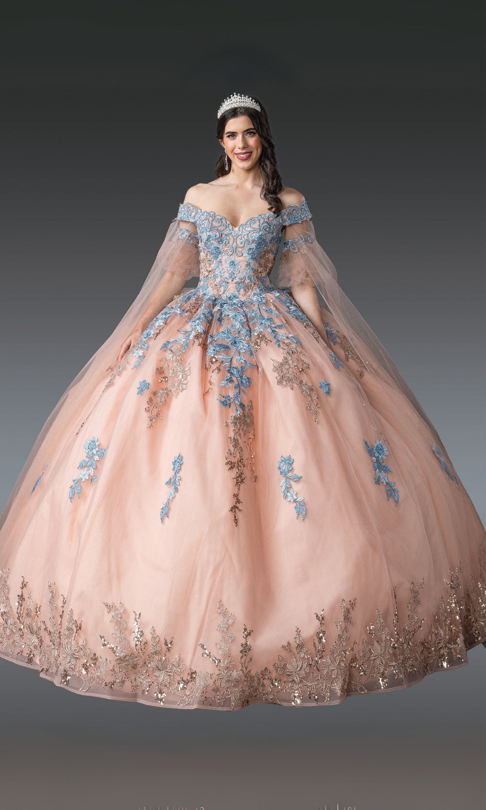 Woman wearing a floral embroidered gown with a dark background