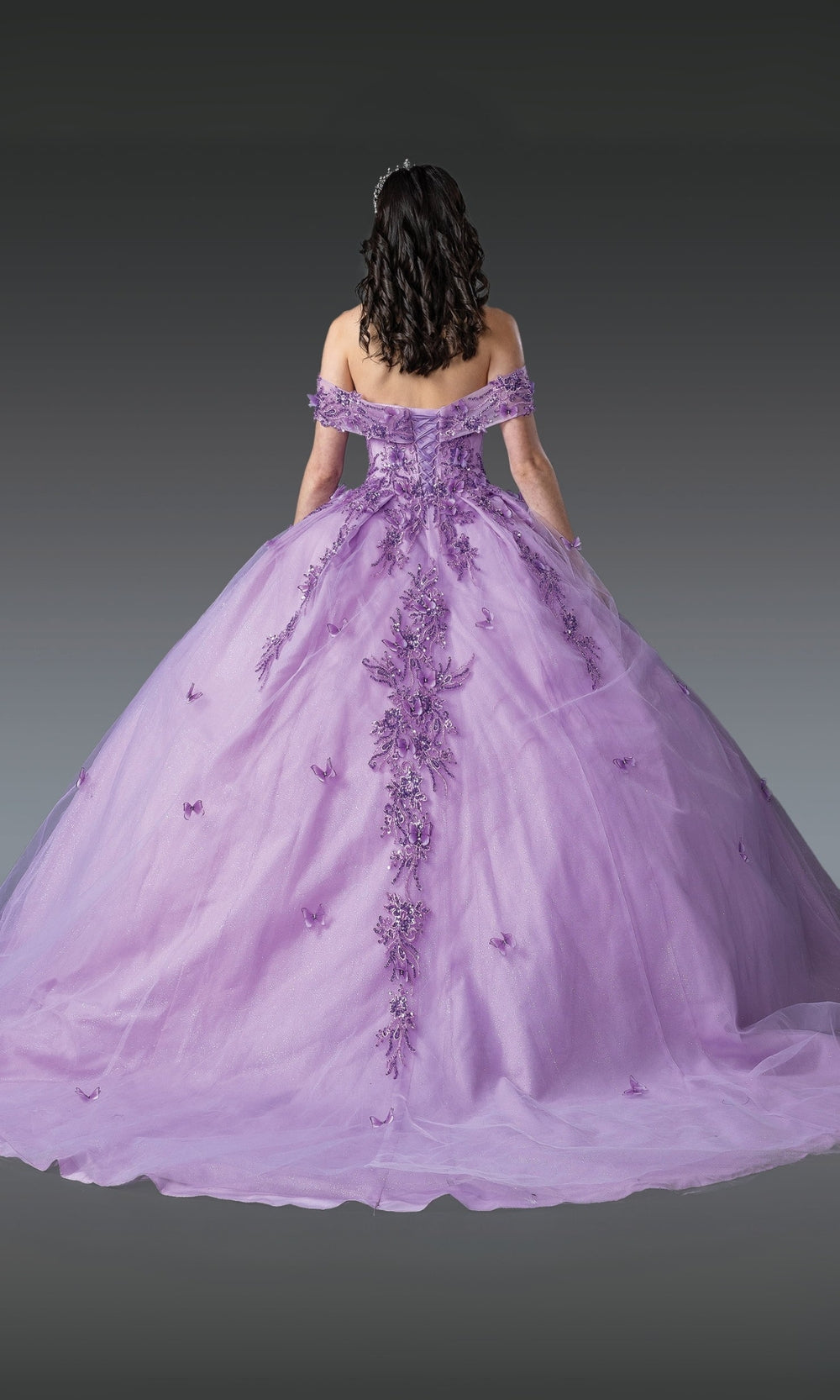 Purple ball gown with intricate detailing on a plain background