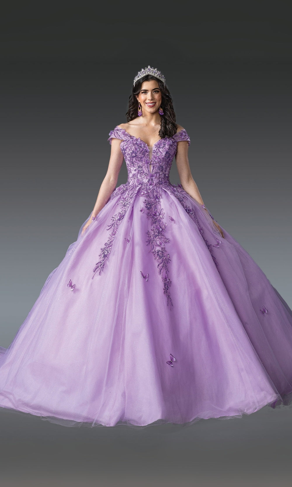 Woman wearing a purple ball gown with floral embroidery on a gray background