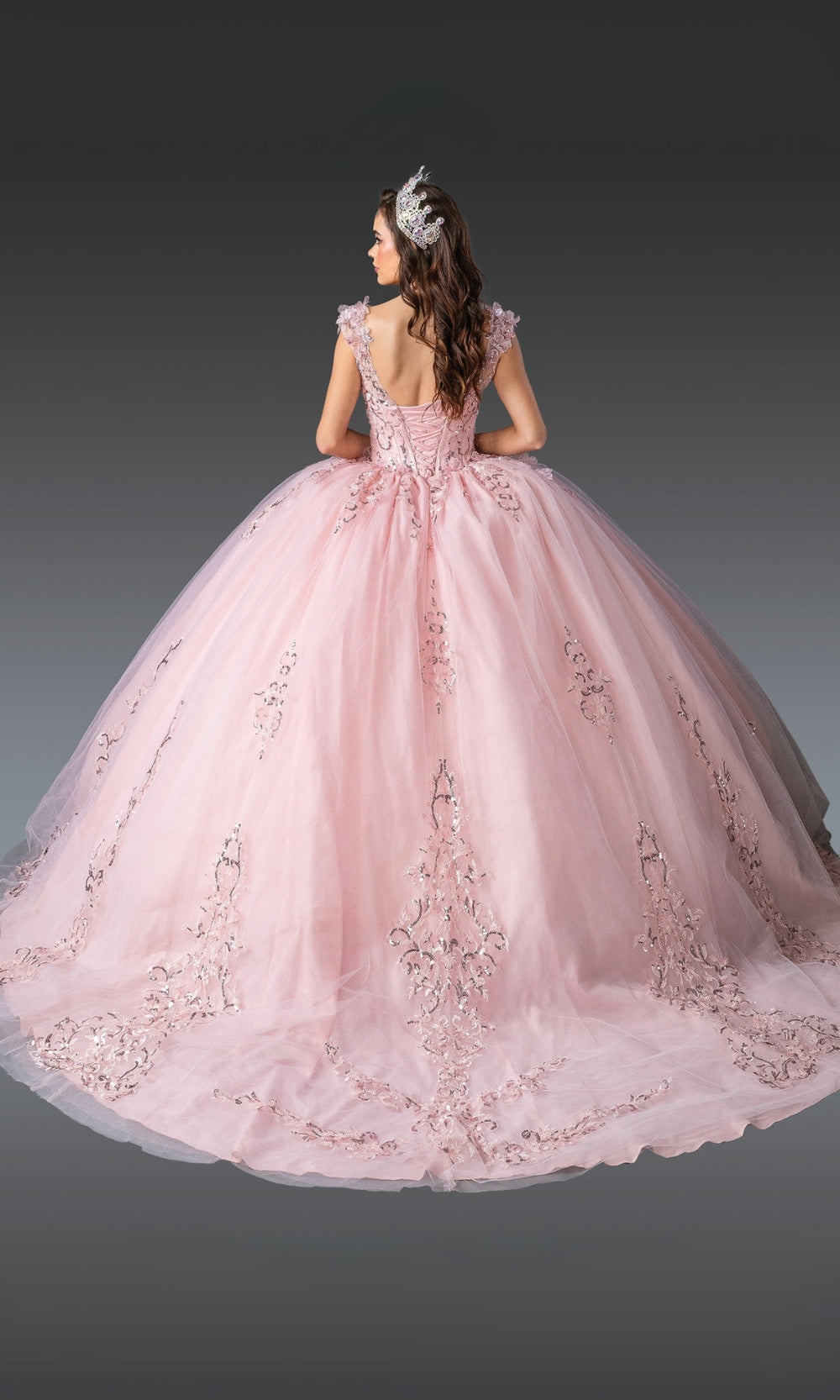 Pink ball gown with floral details on a gray background