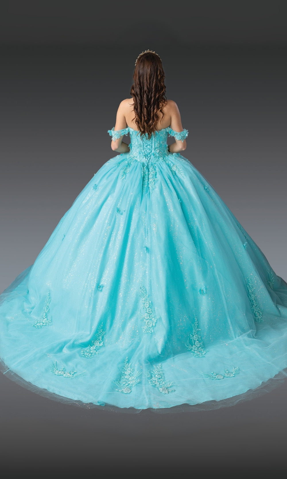 Turquoise ball gown with floral details on a plain background