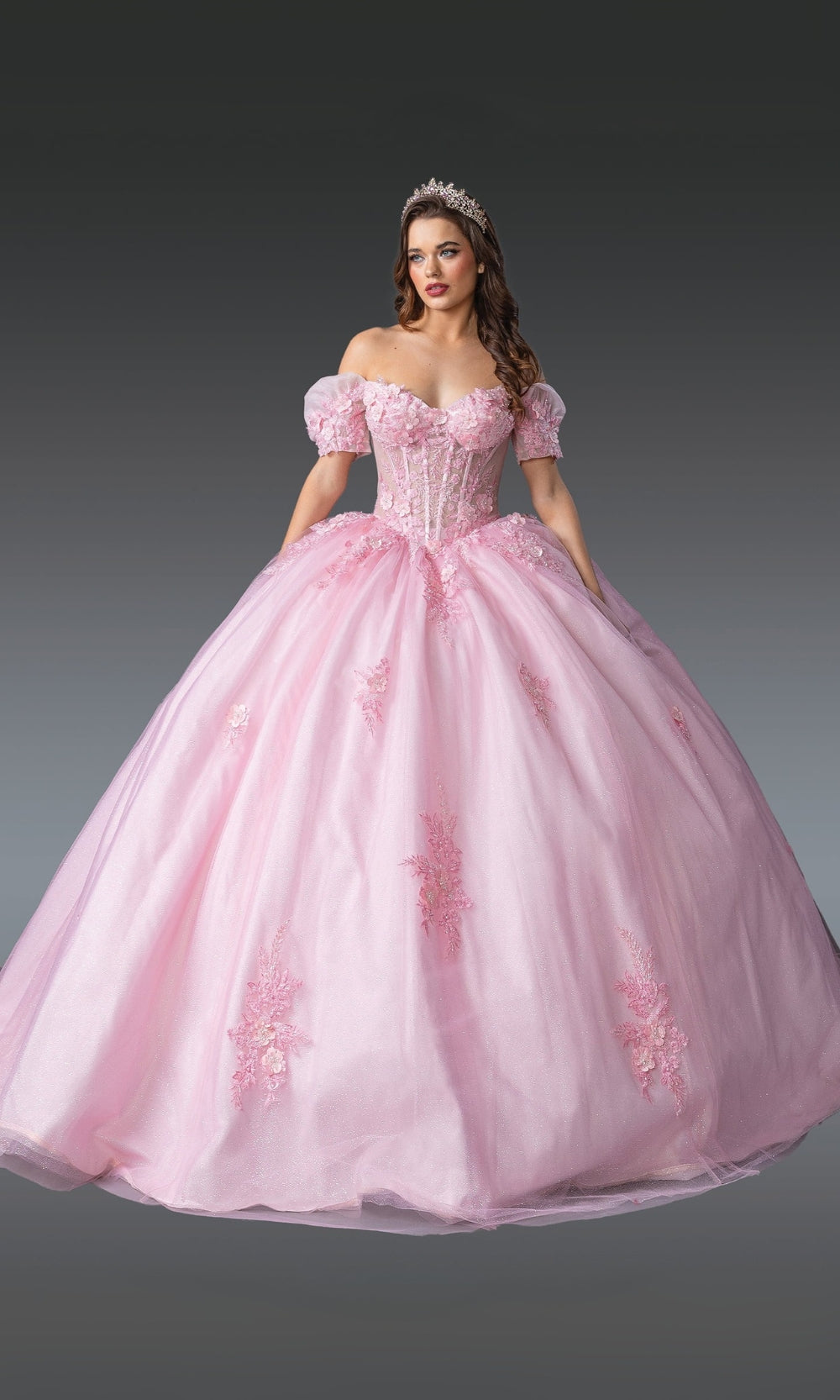 Pink ball gown with floral details on a gray background