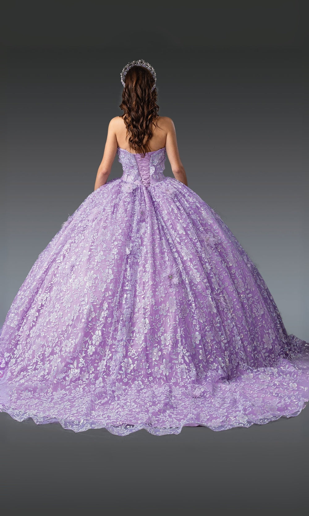 Purple ball gown with floral details on a dark background