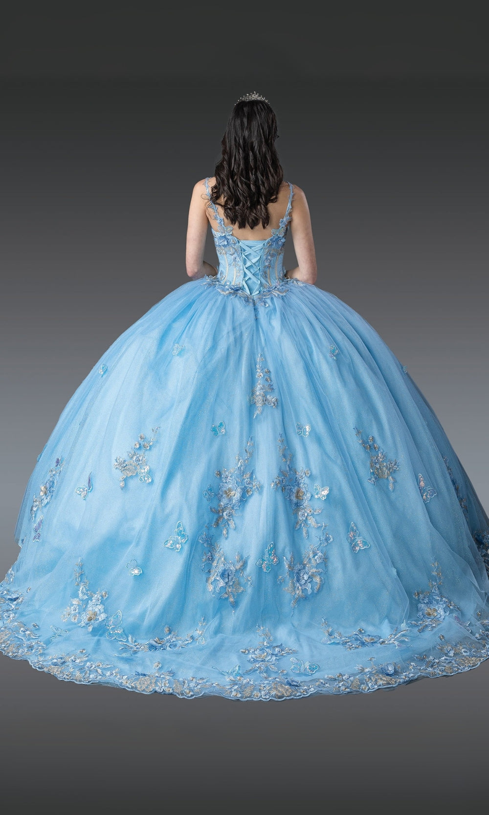 Light blue ball gown with floral embroidery on a dark background