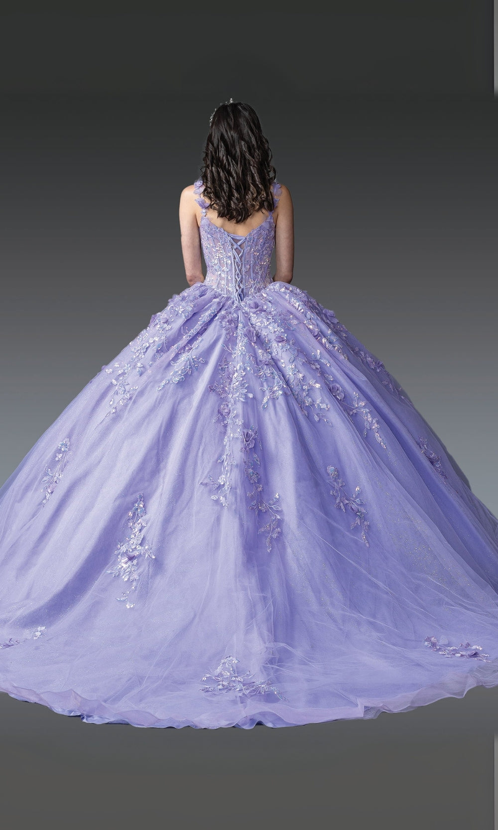 Purple ball gown with intricate details on a plain background