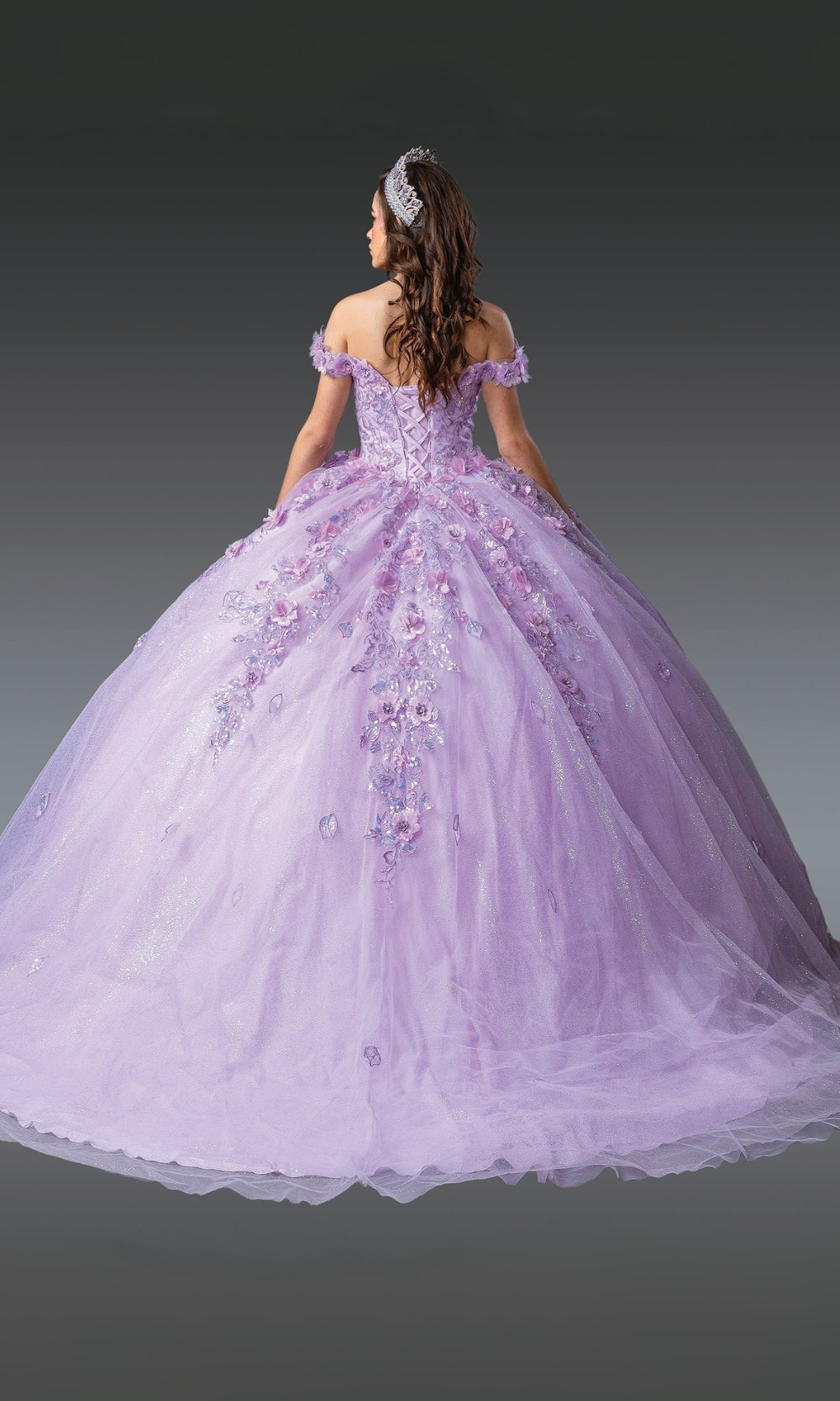 Purple ball gown with floral details on a plain background