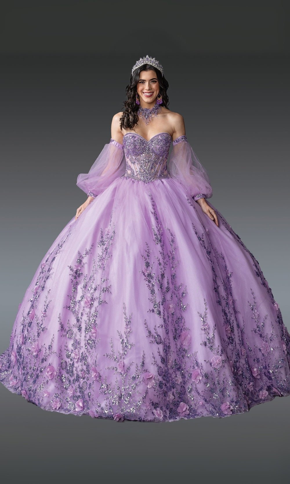Woman wearing a purple ball gown with floral details on a gray background