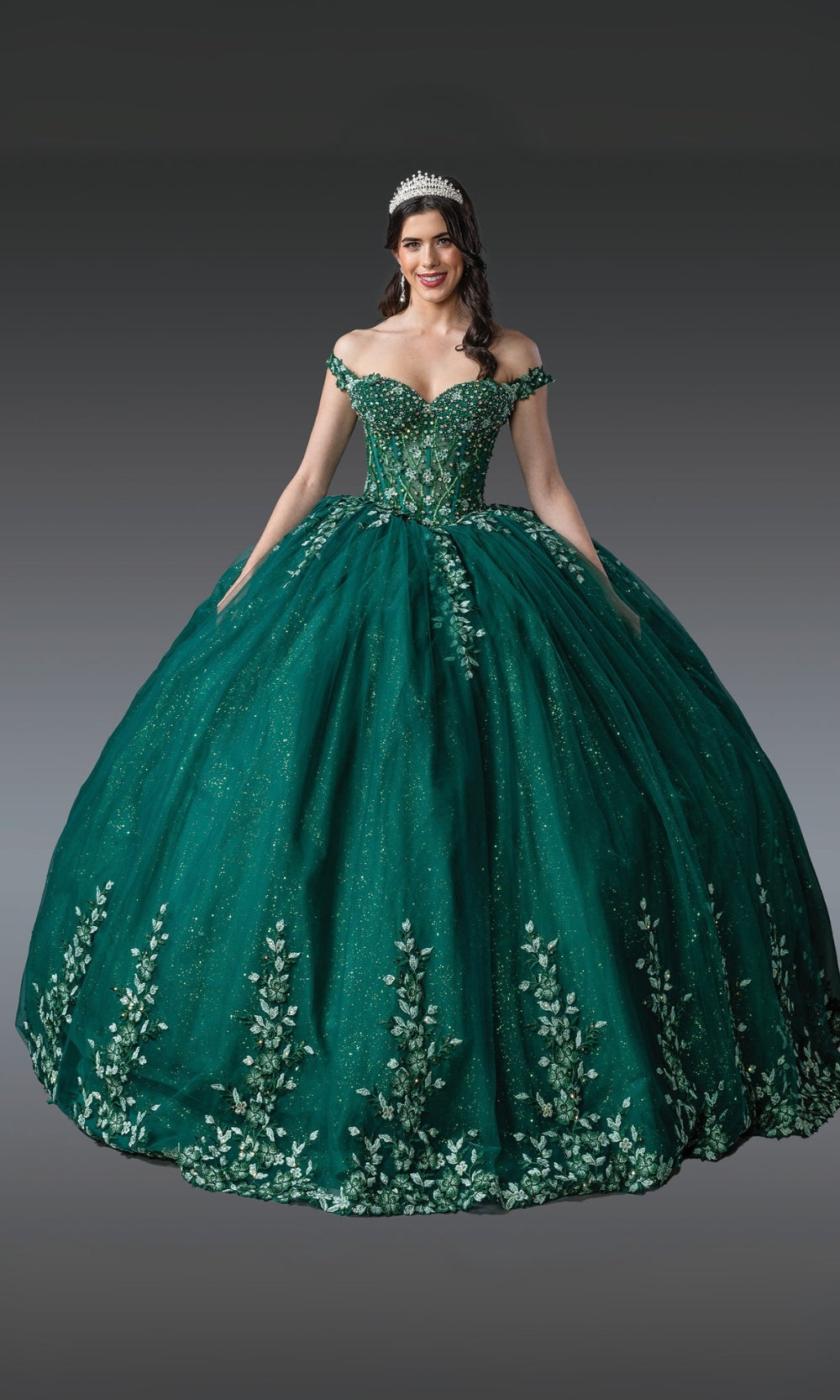 Green ball gown with floral embroidery on a gray background