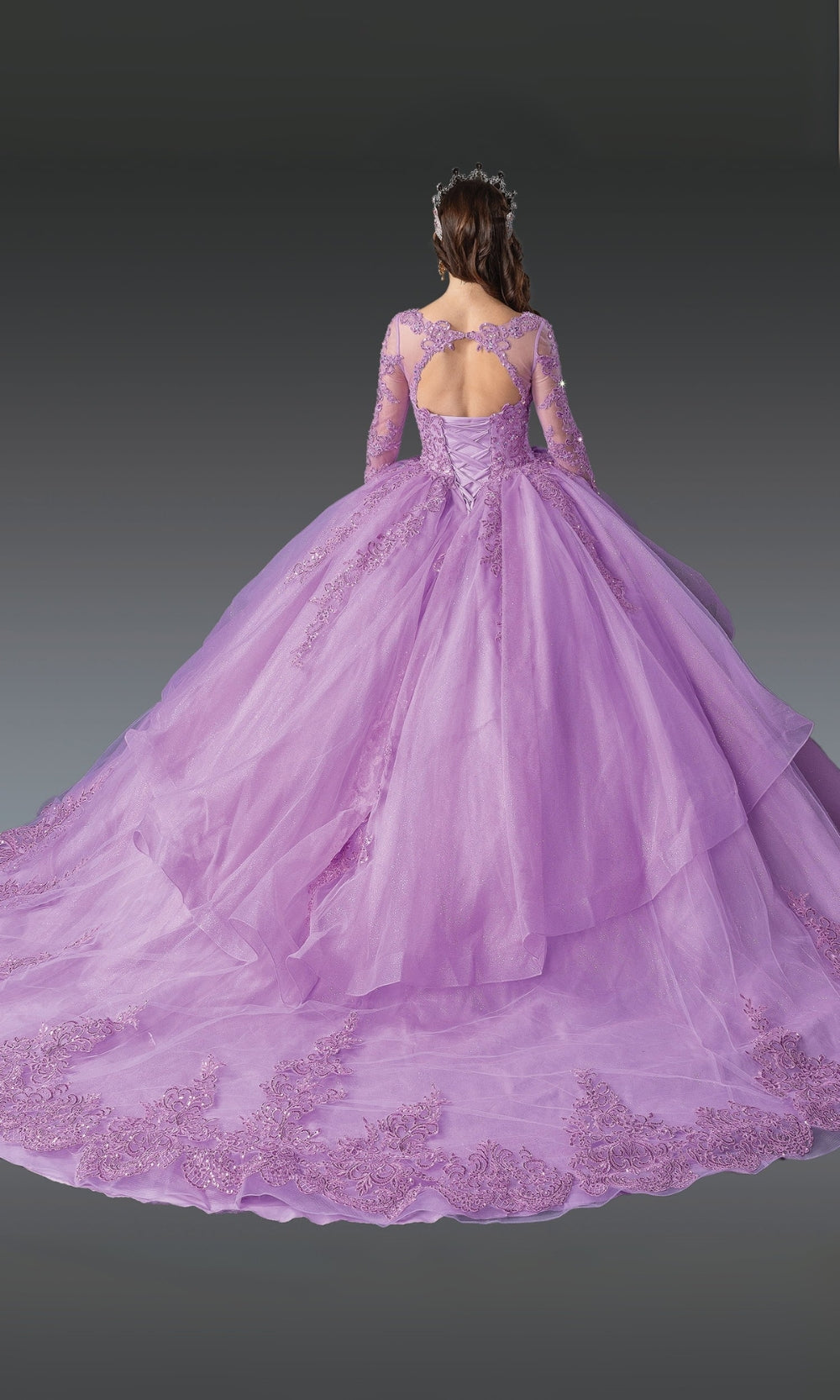 Purple ball gown with intricate detailing on a dark background