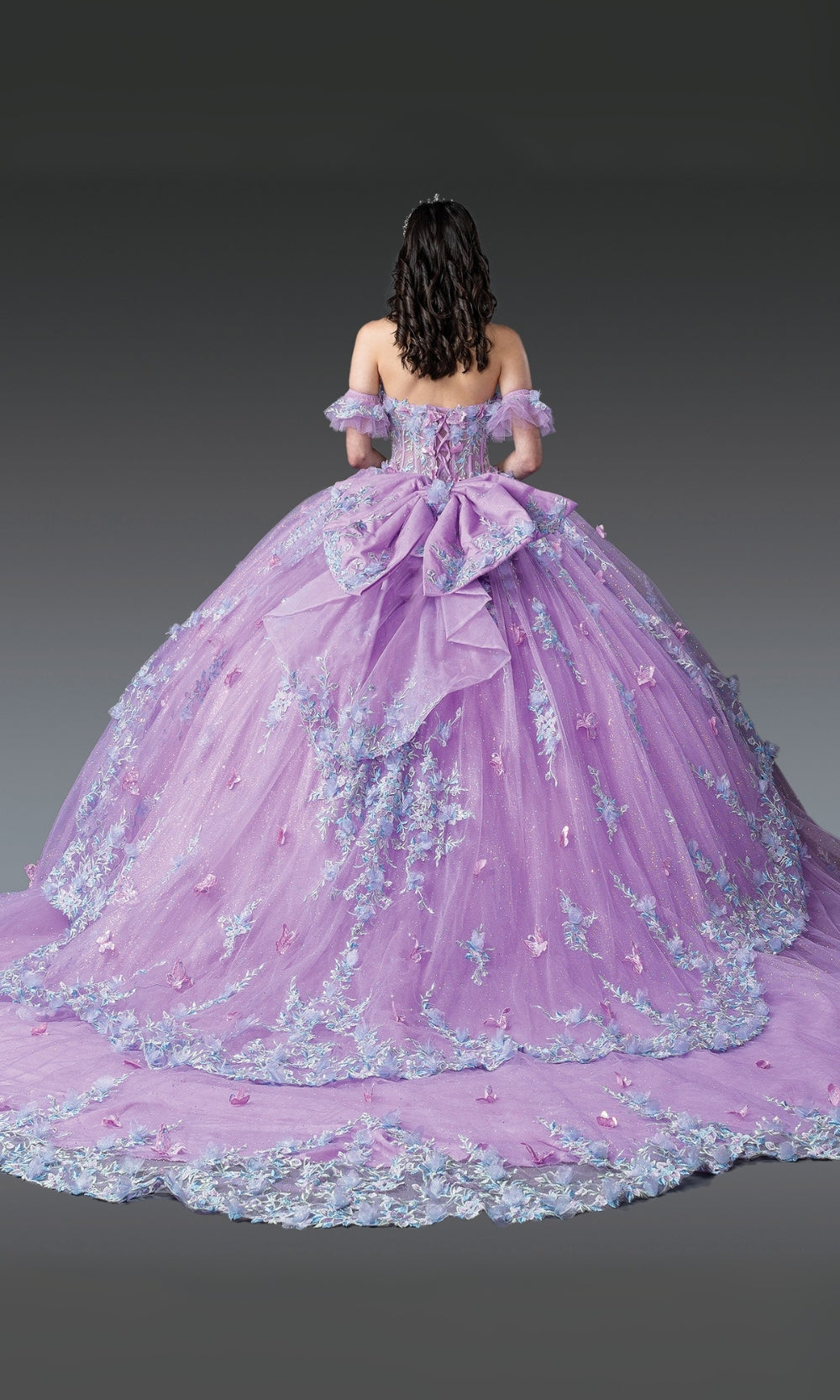 Purple ball gown with floral details on a dark background