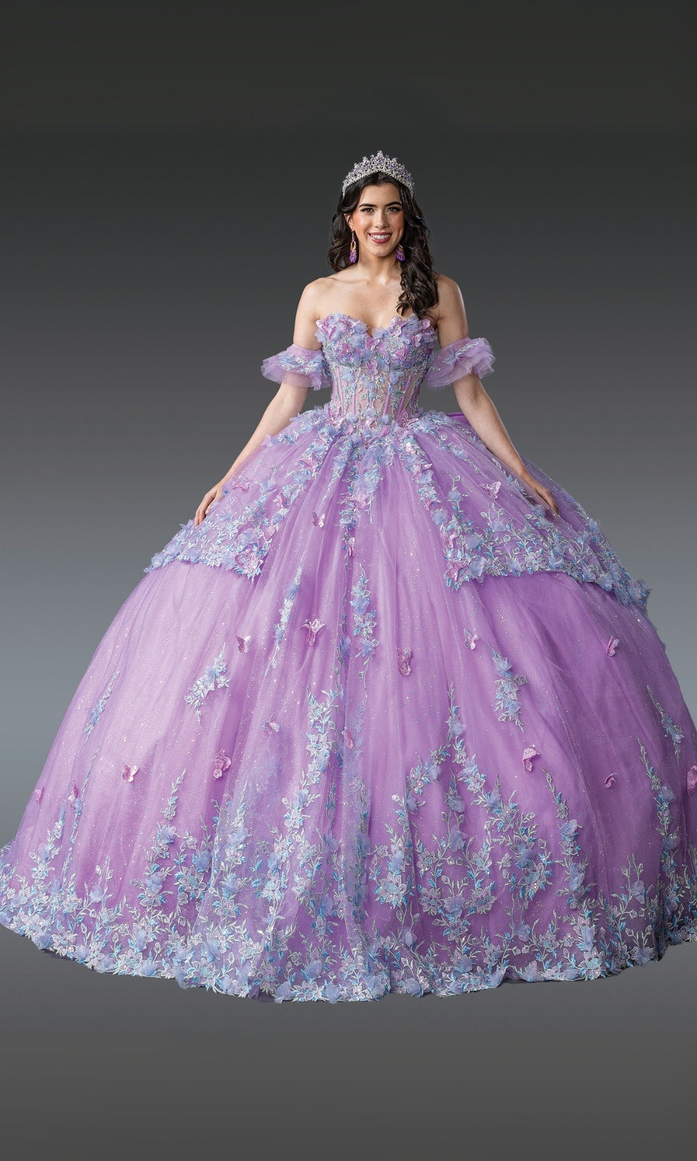 Woman wearing a purple and blue floral ball gown on a gray background