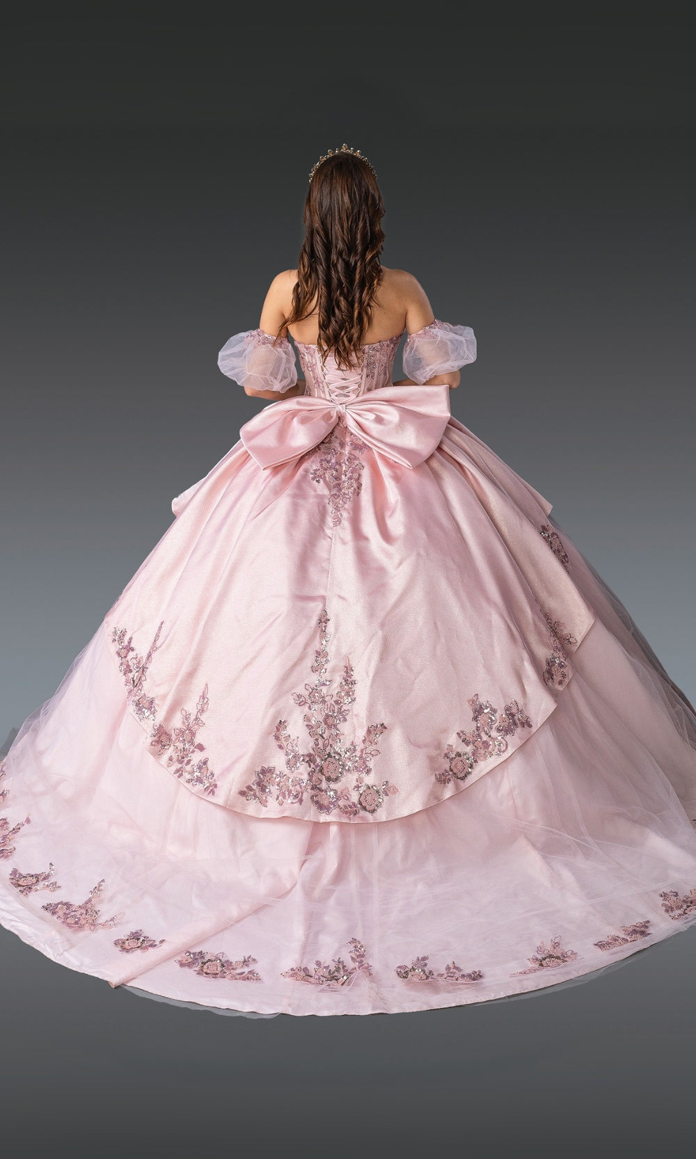 Pink ball gown with floral embroidery on a gray background
