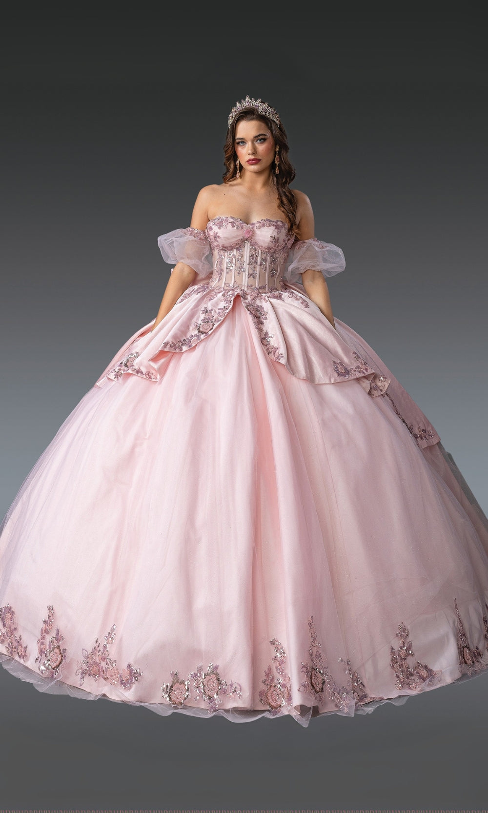 Pink ball gown with floral embroidery on a gray background