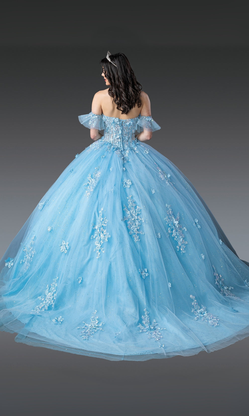 Blue evening gown with floral embroidery on a dark background
