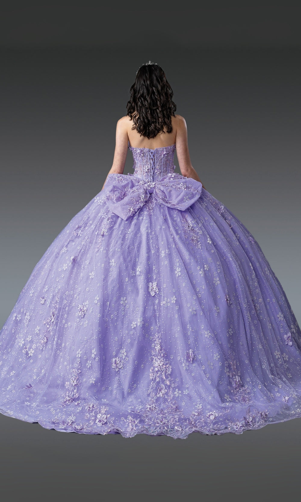 Purple ball gown with a large bow on a gray background
