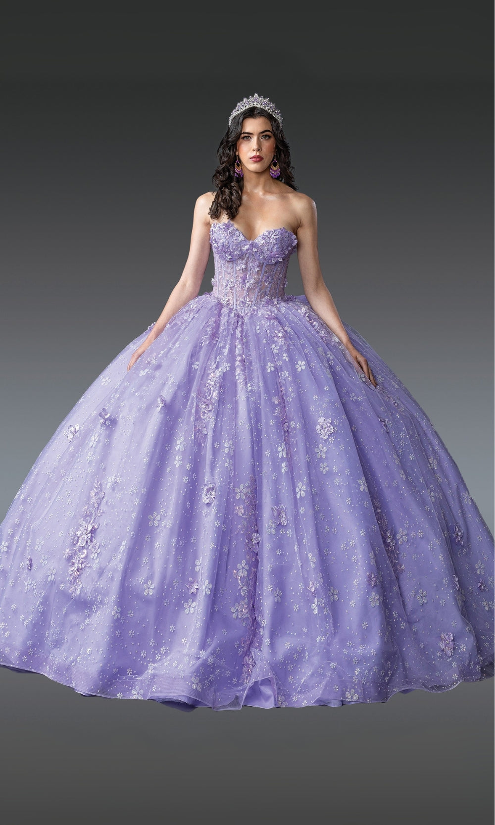 Woman wearing a purple ball gown with floral embroidery on a dark background