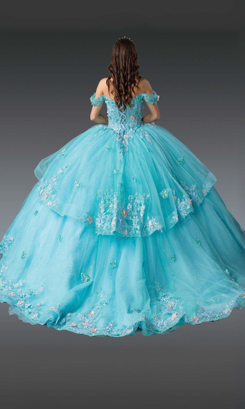 Turquoise ball gown with floral embroidery on a dark background