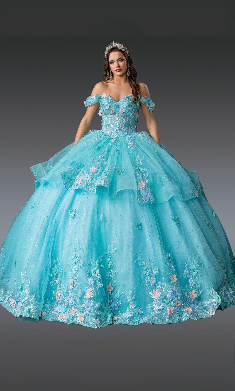 Turquoise quinceañera dress with floral details on a gray background