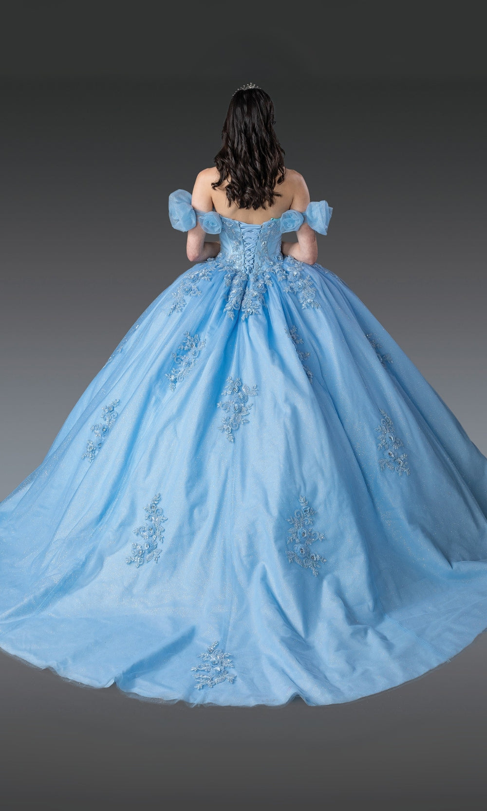 Blue ball gown with intricate details on a plain background
