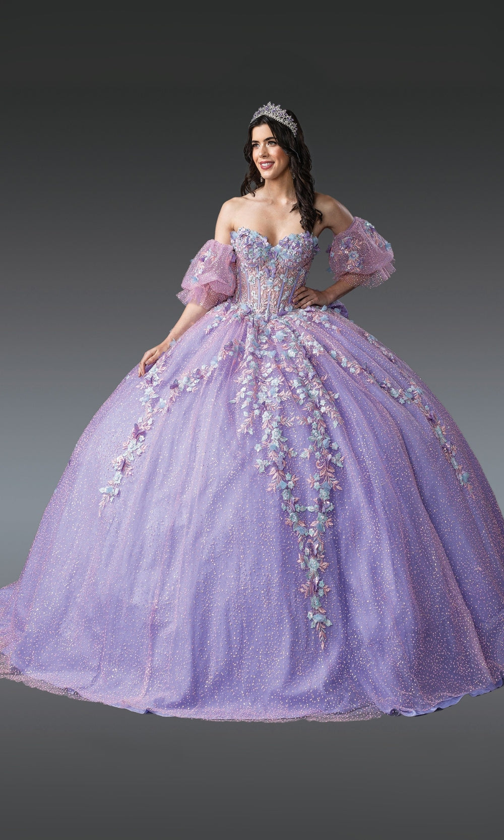 Woman wearing a lavishly decorated purple gown with floral details on a gray background