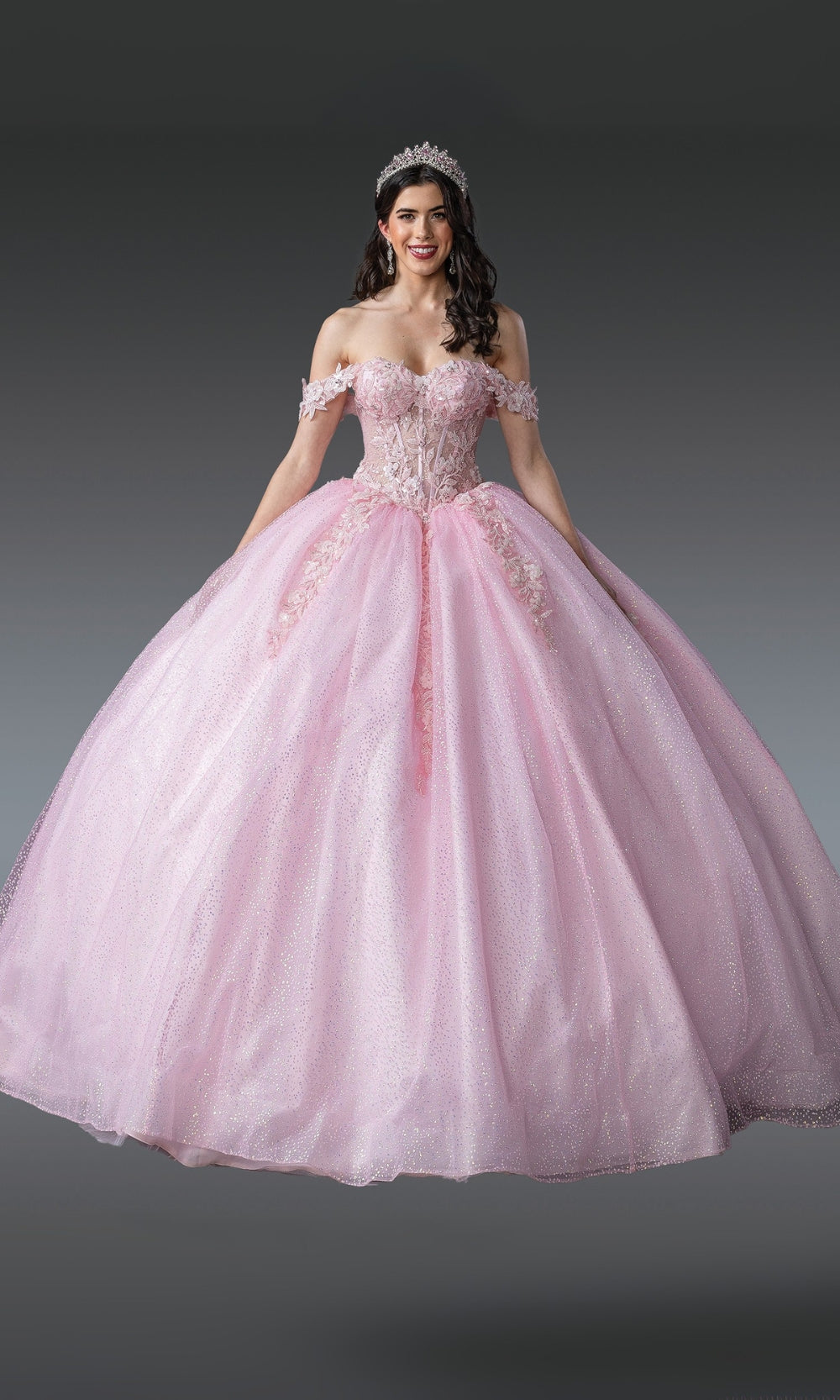 Pink ball gown with floral details on a gray background