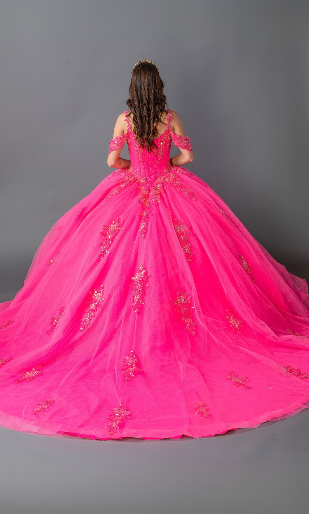 Pink ball gown with gold embroidery on a gray background