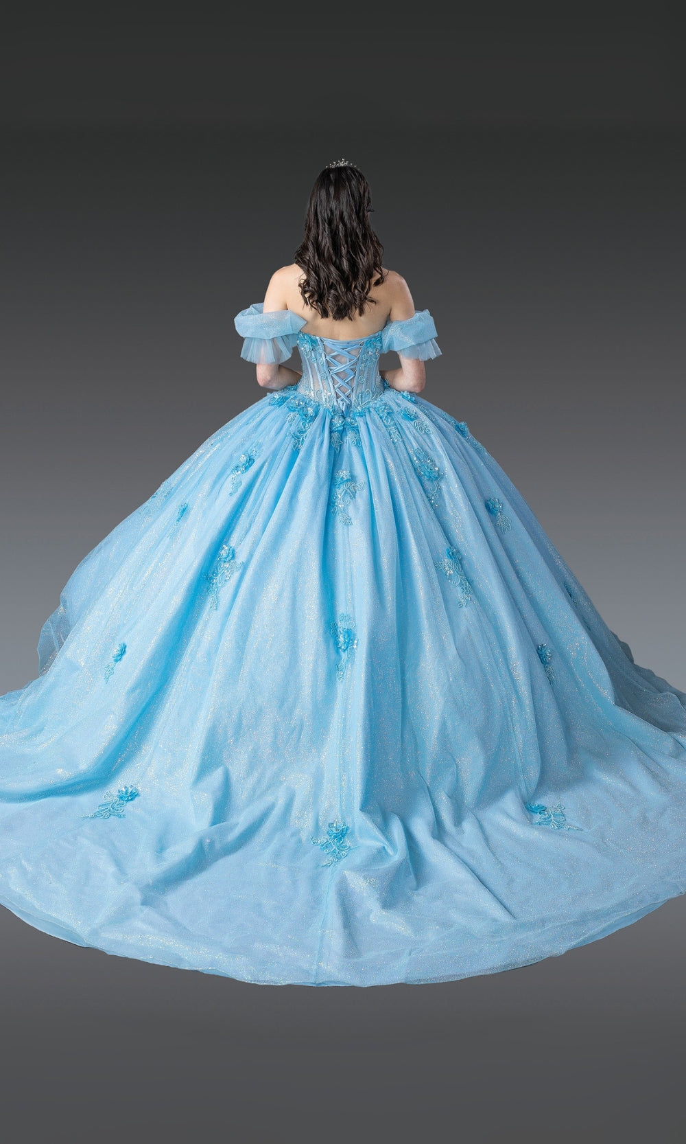 Light blue ball gown with off-shoulder design on a gray background