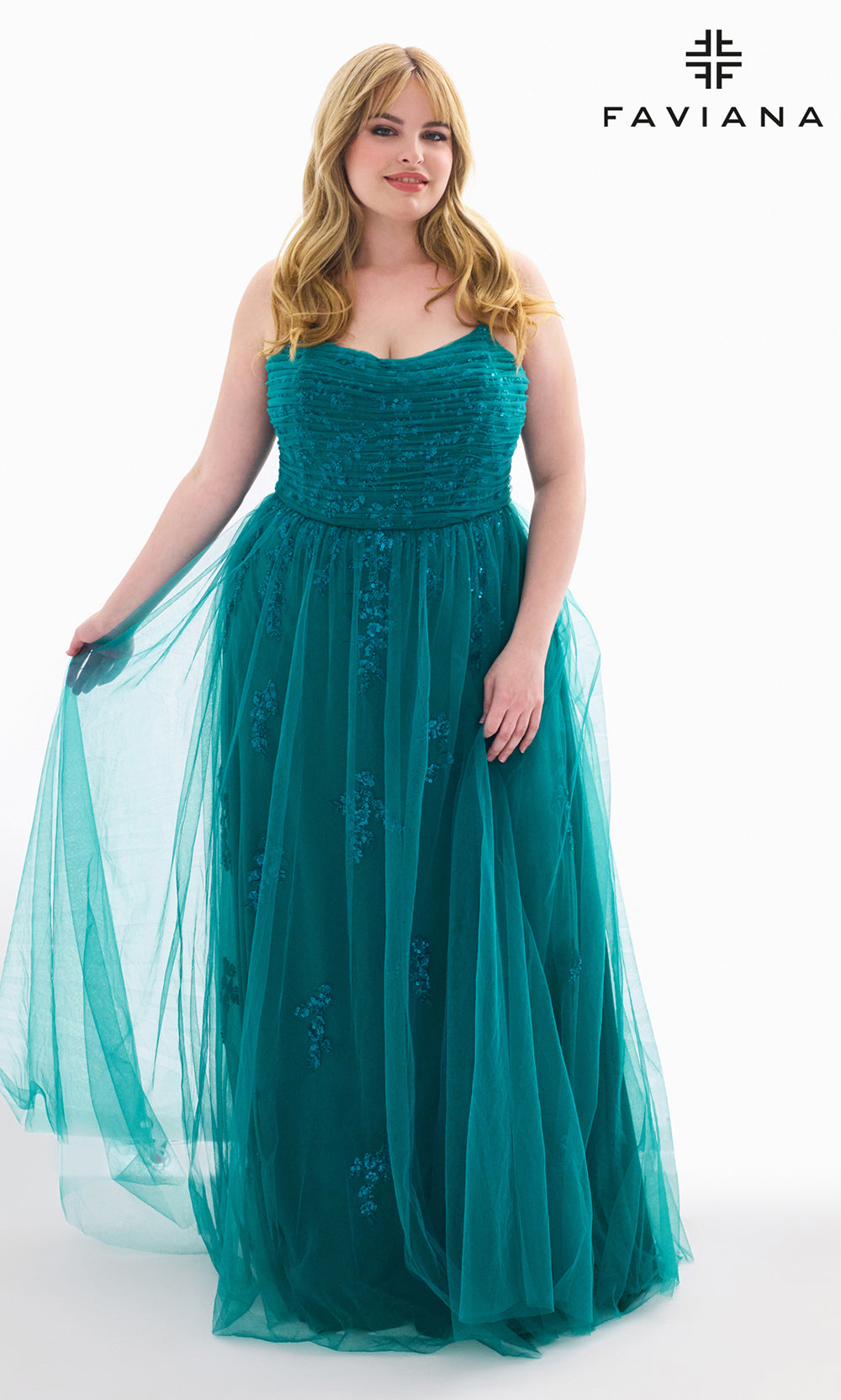 Woman wearing a teal evening gown with Faviana branding.