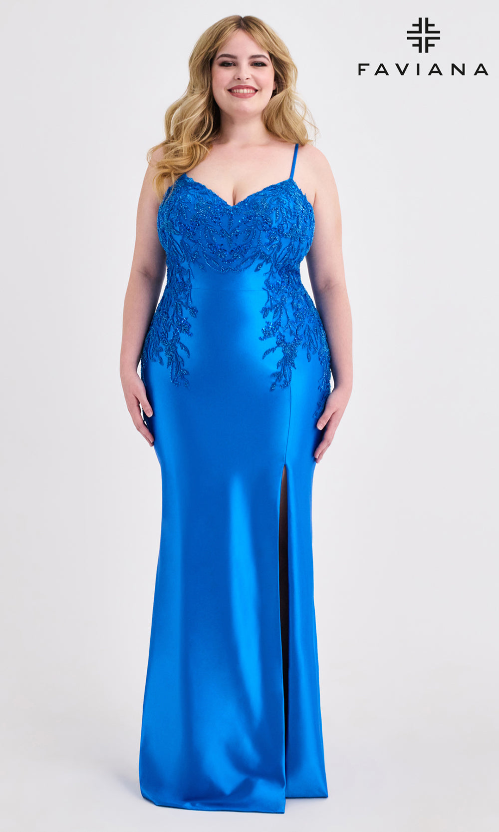 Woman wearing a blue evening gown with lace detailing on a white background, branded 'Faviana'.