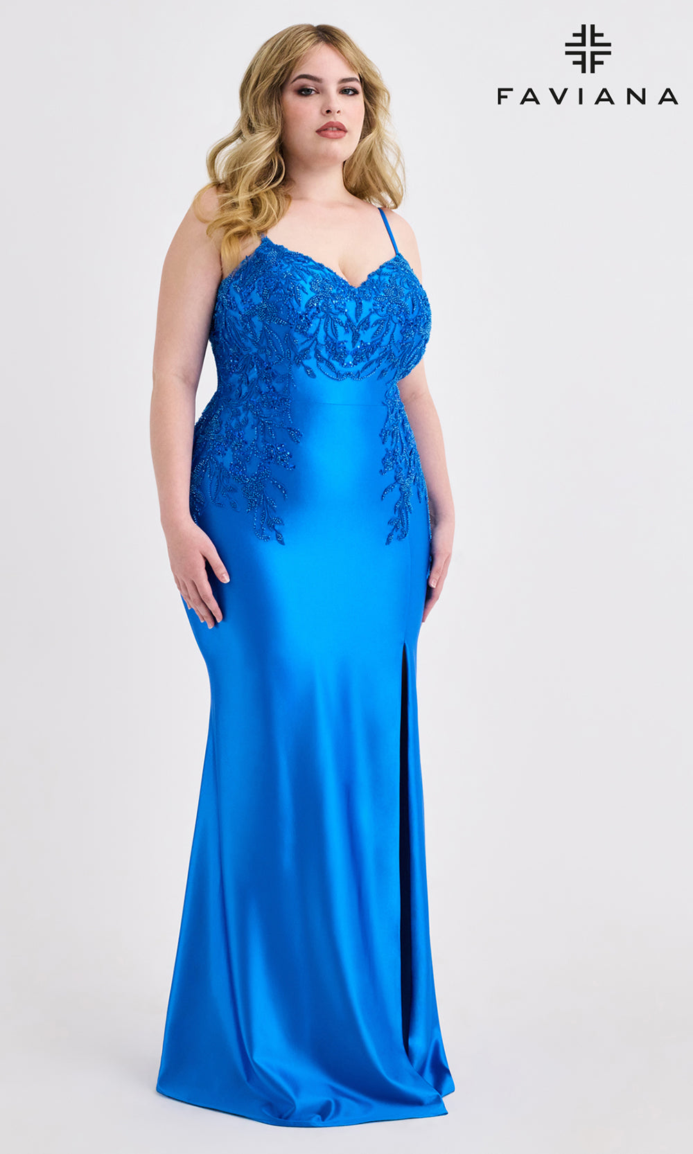 Woman wearing a blue evening gown with lace detailing on a white background, branded 'Faviana'.