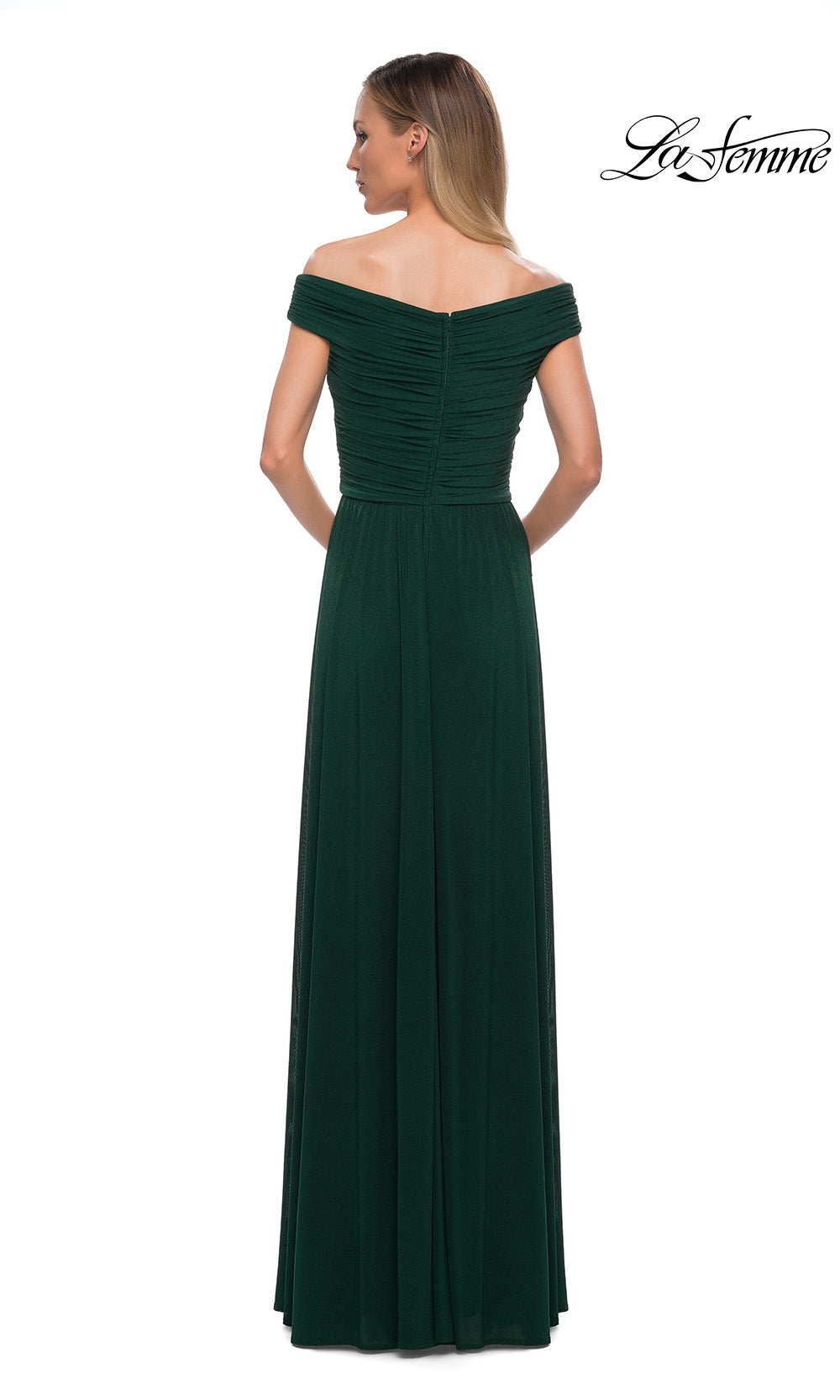 Woman wearing a green off-shoulder evening gown on a white background