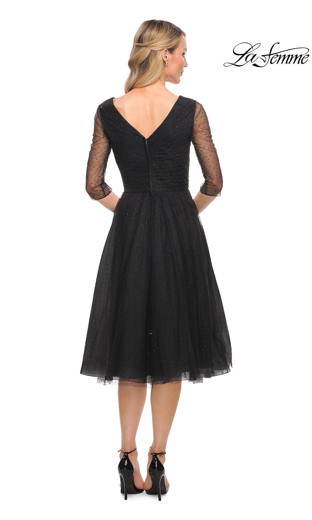 Black dress with sheer sleeves on a white background