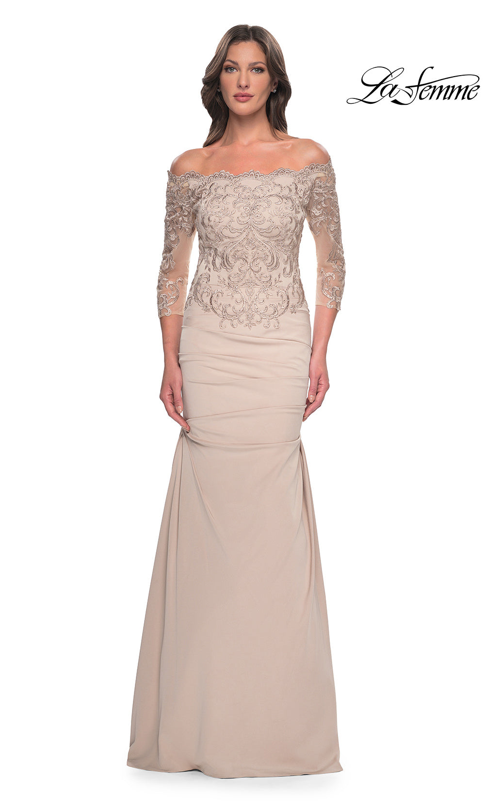 Woman wearing a beige evening gown with lace top on a white background