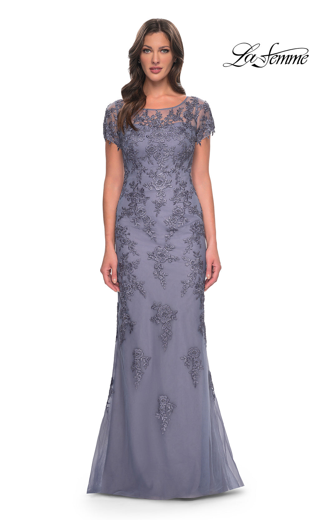 Woman wearing a gray lace evening gown on a white background