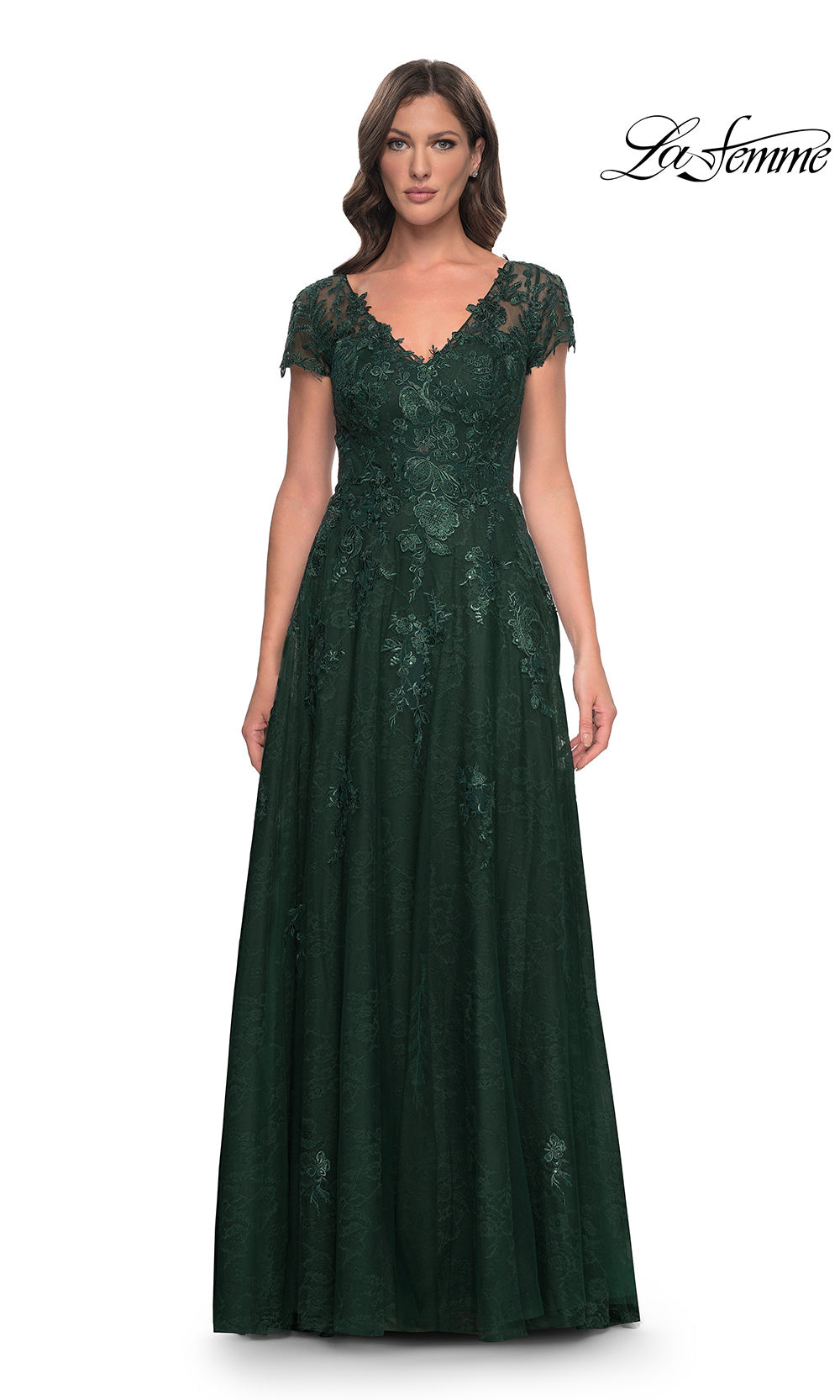 Woman wearing a green lace evening gown on a white background