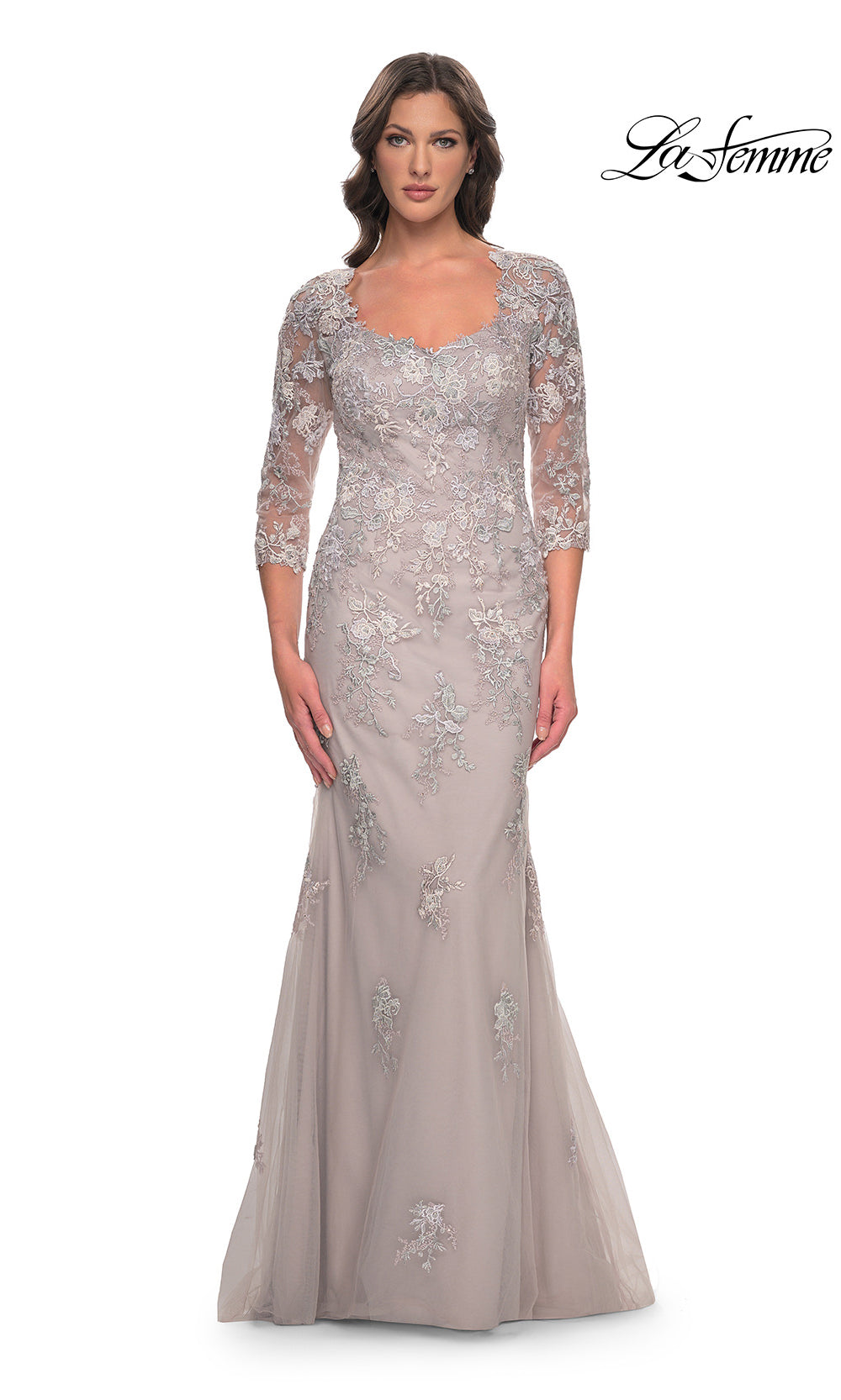 Woman wearing a silver evening gown with lace details on a white background