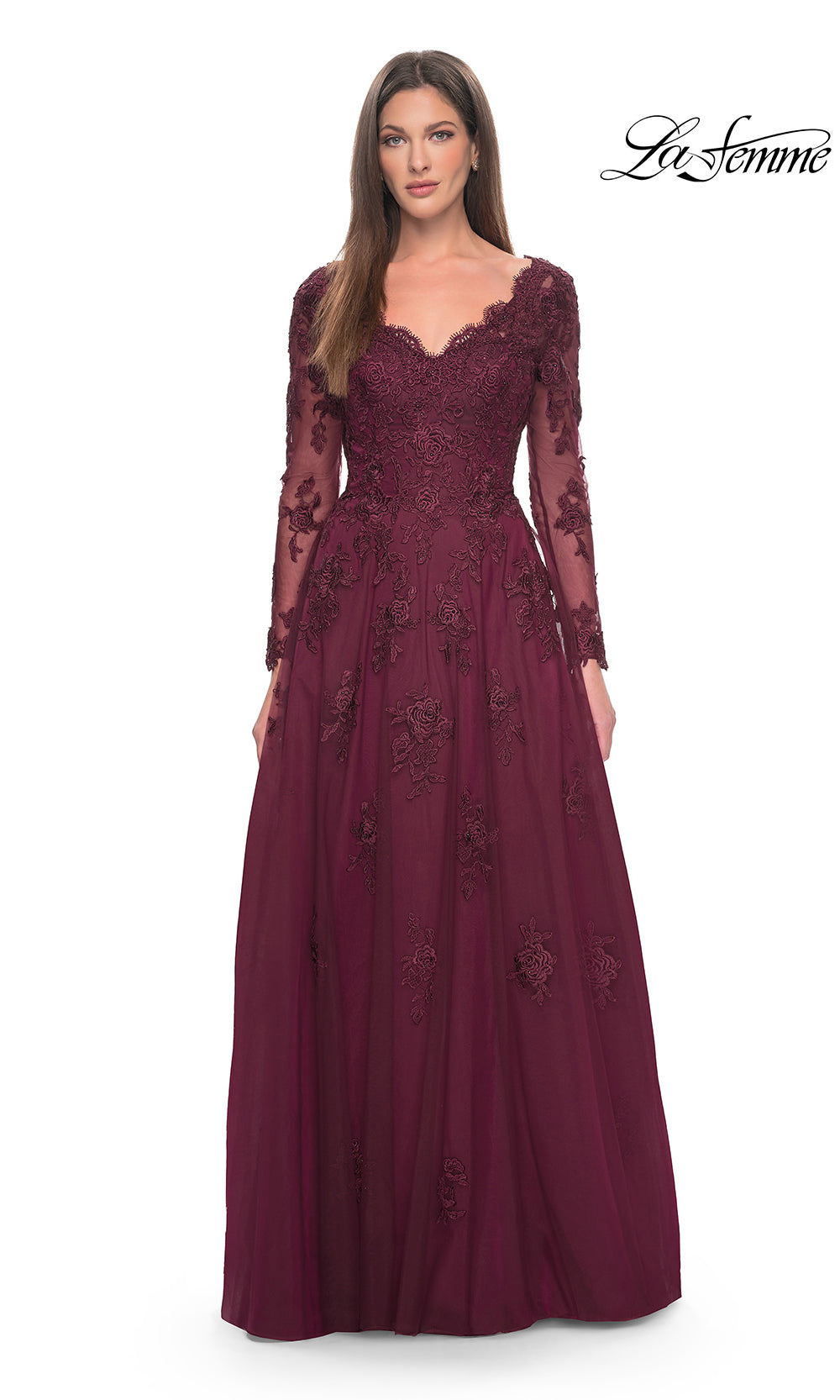 Woman wearing a burgundy evening gown with lace details on a white background