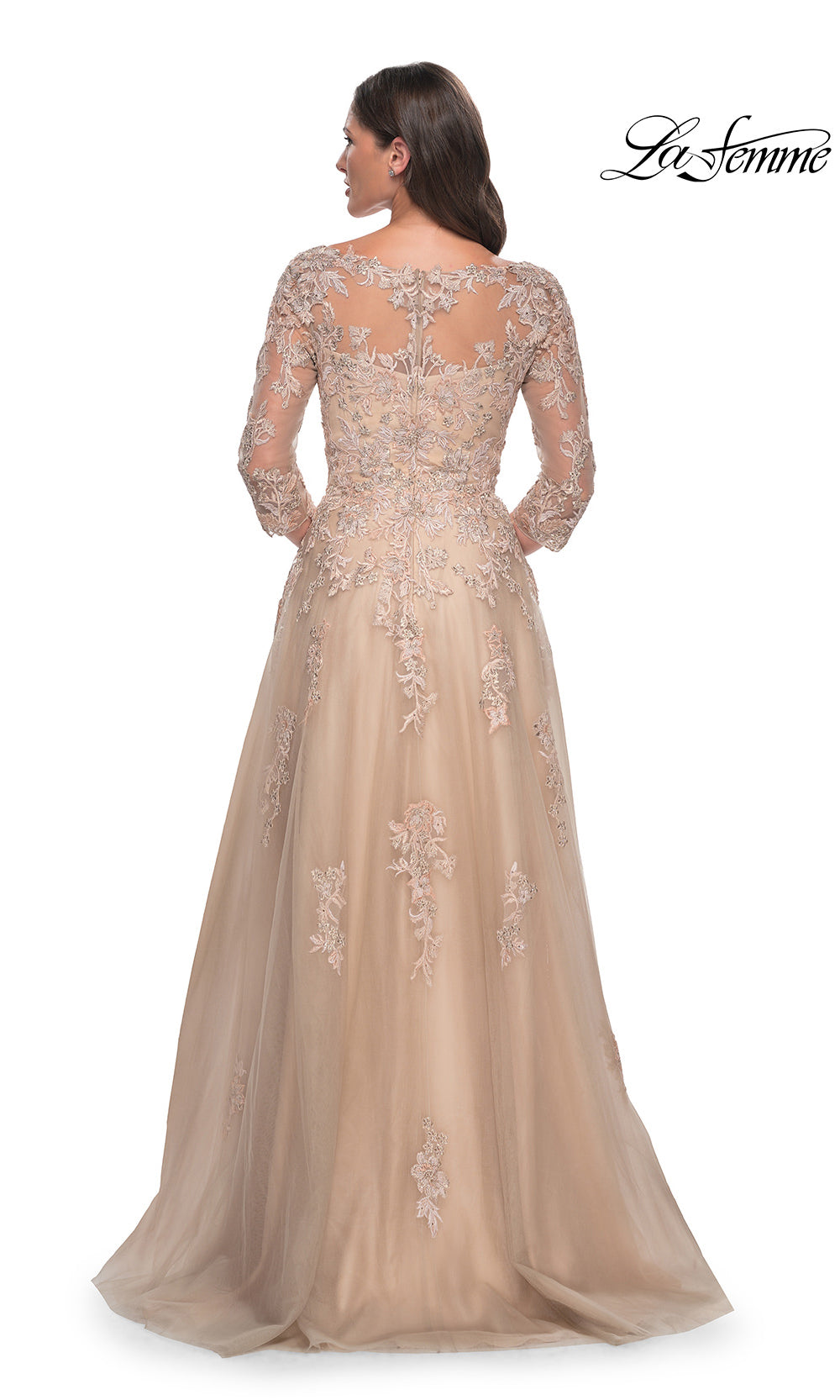 Beige evening gown with intricate lace details on a white background