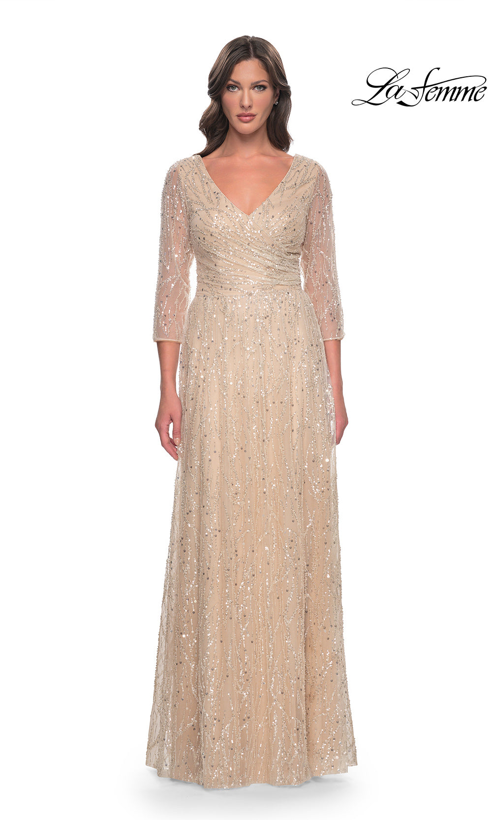 Woman wearing a long, elegant dress with a V-neck and long sleeves on a white background. Brand 'La Femme' visible.