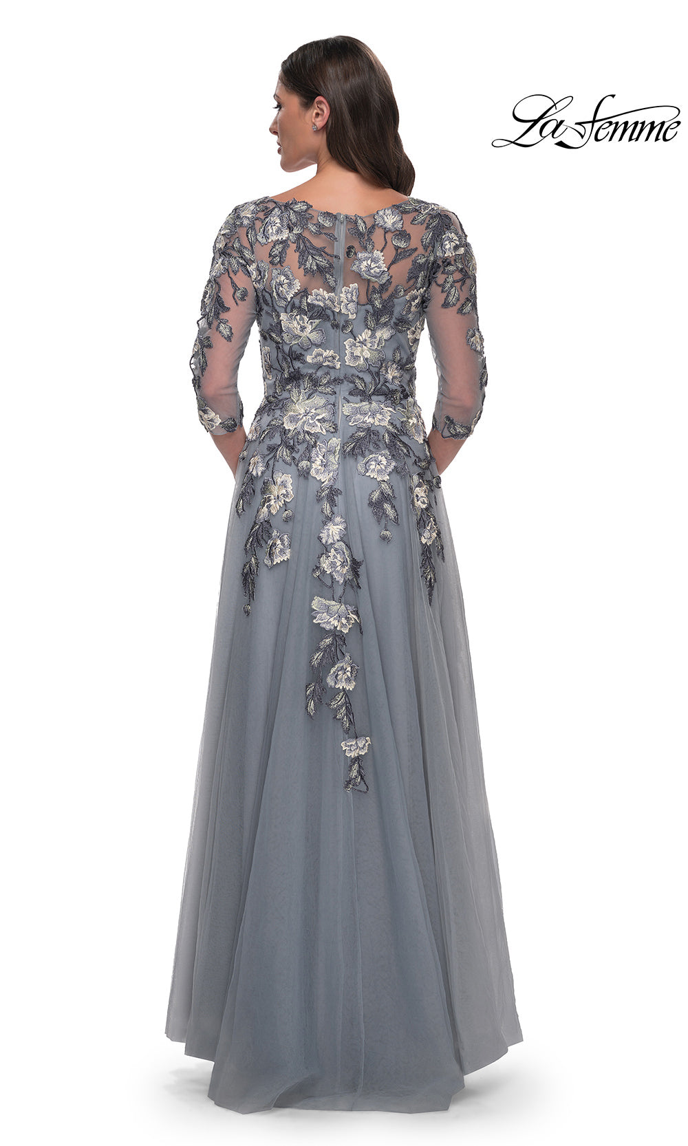 Long evening gown with floral lace detailing on a white background